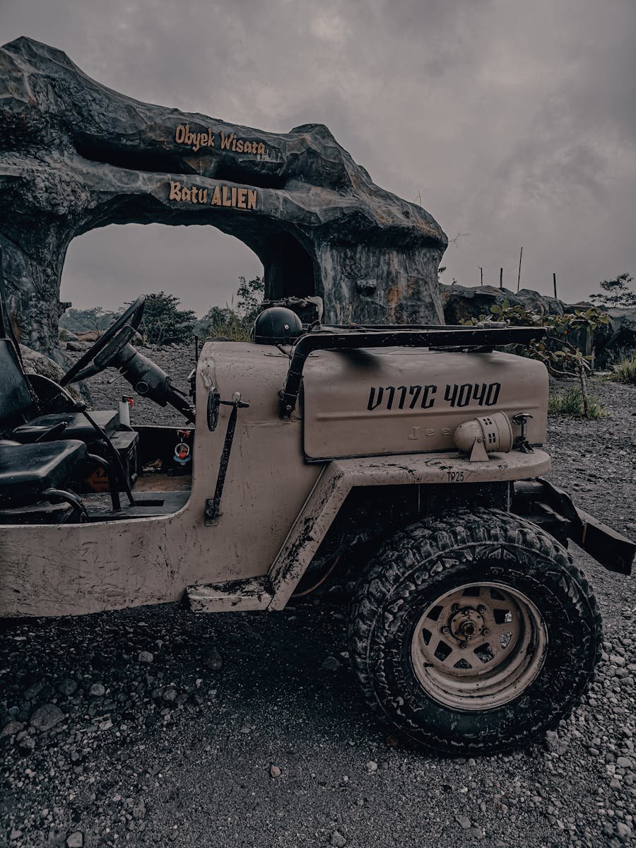 A vintage jeep parked near the Batu Alien, a popular attraction in Yogyakarta, Indonesia.