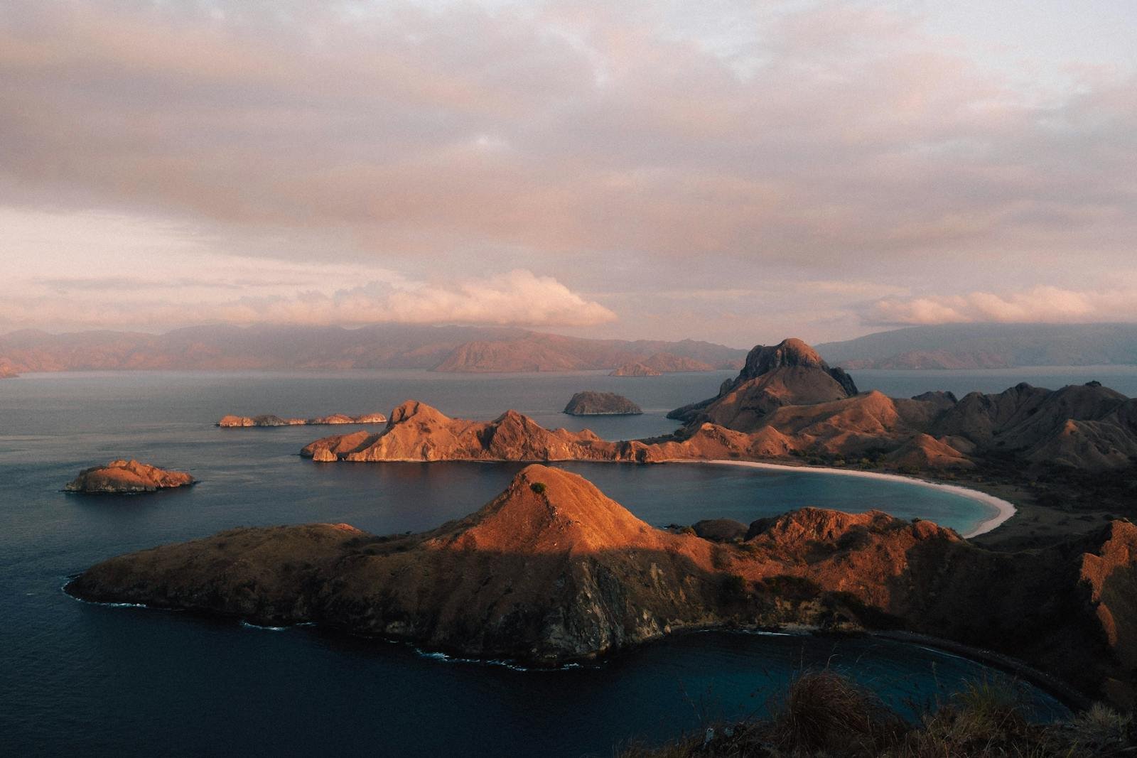 A breathtaking sunset view over the rugged coastline of Padar Island in Komodo National Park, Nusa Tenggara Timur Indonesia.